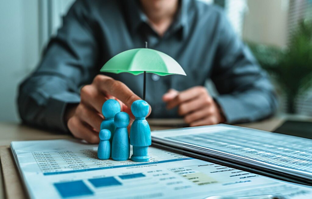 A businessman stands with an umbrella, shielding his family from rain, representing support and security.